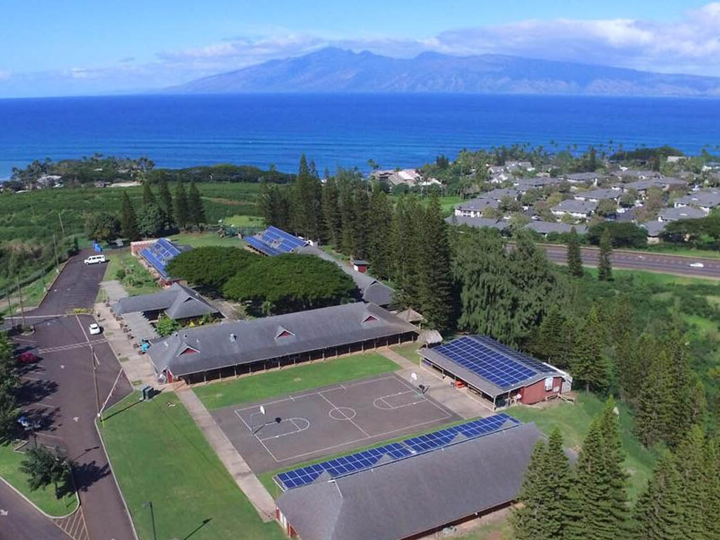 Aerial view of the Maui Preparatory Academy campus, with the ocean and West Maui Mountains in the background